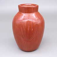 Red jar with a carved bear paw design on two sides
 by Alvin Baca of Santa Clara
