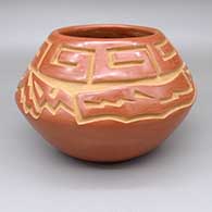 Red jar with a carved avanyu and geometric design
 by Chris Martinez of Santa Clara