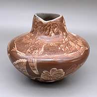 Sienna jar with an organic opening and a sgraffito hummingbird, flower, leaf, and branch design
 by Bernice Naranjo of Taos