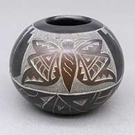 Small black jar with a sienna spot and a sgraffito butterfly, feather ring, raincloud, kiva step, and geometric design
 by Candelaria Suazo of Santa Clara