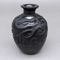 Small black jar with a carved stylized avanyu and geometric design
 by Tammy Garcia of Santa Clara