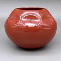 Polished red jar with an indented design
 by Tina Garcia of Santa Clara