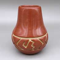 Red jar with a carved geometric design
 by Margaret Tafoya of Santa Clara