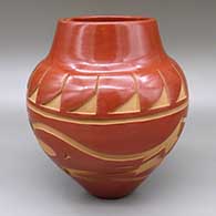 Large red jar with a carved avanyu and feather ring geometric design
 by Sherry Tafoya of Santa Clara