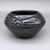 Black bowl with a carved avanyu and geometric design
 by Chris Martinez of Santa Clara
