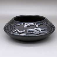 Black jar with a carved avanyu and kiva step geometric design
 by Chris Martinez of Santa Clara