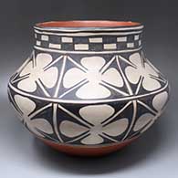 A polychrome jar decorated with a band of checkerboard design below a sky band and above two bands of geometric design above a wide Earth band
 by Robert Tenorio of Santo Domingo