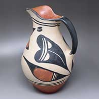 A polychrome pitcher decorated with a flower and geometric design
 by Unknown of Santo Domingo