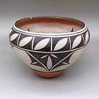 Polychrome jar with a traditional Kewa design featuring flower and geometric elements on both the inside and outside
 by Ambrose Atencio of Santo Domingo