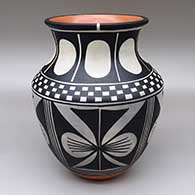 A polychrome jar with a flared opening and a traditional Kewa design featuring checkerboard, butterfly and geometric elements
 by Thomas Tenorio of Santo Domingo