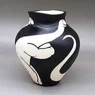 Black-on-white jar with an organic form, a slightly flared opening, and a brontosaurus dinosaur design
 by William Pacheco of Santo Domingo