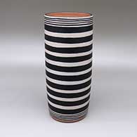 Polychrome cylinder with a striped geometric design
 by Thomas Tenorio of Santo Domingo