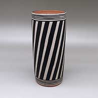 Polychrome cylinder with a striped geometric design
 by Thomas Tenorio of Santo Domingo