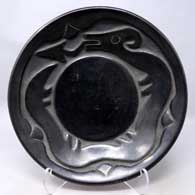 Shallow black bowl carved with an avanyu and geometric design
 by Rose Gonzales of San Ildefonso