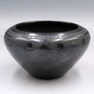 Black-on-black bowl with a band of geometric design around and above the shoulder
 by Tonita Roybal of San Ildefonso