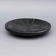 Black-on-black plate with a geometric design, click or tap to see a larger version