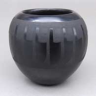 Small black-on-black jar with a feather ring geometric design
 by Marvin and Frances Martinez of San Ildefonso