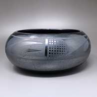 A black-on-black bowl decorate above the shoulder with a four-panel geometric design
 by Maria Martinez of San Ildefonso