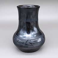 Black-on-gunmetal-black jar with a long neck, a slightly flared opening, and a four-panel geometric design
 by Maria Martinez of San Ildefonso
