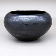 A black-on-black bowl decorated with a four-panel spiral, kiva step and geometric design
 by Maria Martinez of San Ildefonso