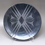 A black-on-black plate with a geometric design
 by Maria Martinez of San Ildefonso