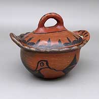 Black and red lidded jar with handles, a flared and scalloped rim, an oblong shape, fire clouds, and a painted bird and geometric design
 by Unknown of San Ildefonso