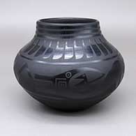 Black-on-black jar with a painted avanyu, feather ring, kiva step, ladder, sun, moon, star, and raincloud design
 by Marvin and Frances Martinez of San Ildefonso
