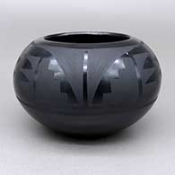 A black-on-black bowl with a feather ring, kiva step, and geometric design
 by Marvin and Frances Martinez of San Ildefonso