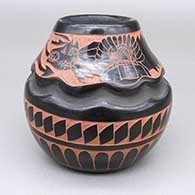 Black and red jar with a carved-and-painted katsina, avanyu, feather ring, and geometric design, includes a Third Prize ribbon from the 1985 Inter-Tribal Indian Ceremonial in Gallup, NM
 by Tom Tapia of Ohkay Owingeh