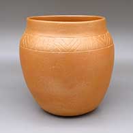 Micaceous gold jar with a sgraffito geometric design
 by Clarence Cruz of Ohkay Owingeh
