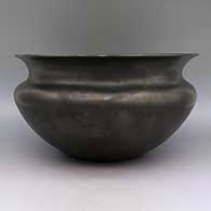 Micaceous black bowl with flared rim and sienna spot on bottom, click or tap to see a larger version