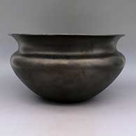 Micaceous black bowl with flared rim and sienna spot on bottom, click or tap to see a larger version