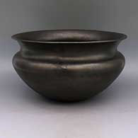 Micaceous black bowl with flared rim and sienna spot on bottom
 by Angie Yazzie of Taos
