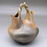 A golden micaceous wedding vase with a twisted handle and fire clouds
 by Angie Yazzie of Taos