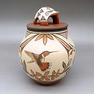 Polychrome lidded jar with a hummingbird, moth, bird, flower, fine line, and geometric design and a matching lid with an applique bear and a painted roadrunner design
 by Marcellus Medina of Zia