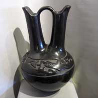 Avanyu design carved into a black wedding vase