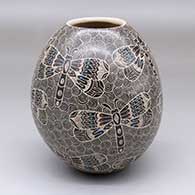 A polychrome jar decorated with a sgraffito-and-painted dragonfly and geometric design