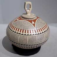 Geometric design plus sculpted lid with geometric design on a polychrome jar