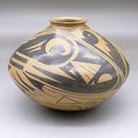 A brown jar with an everted lip and a black, four-panel bird and geometric design