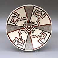 A polychrome plate decorated with a fineline and geometric design
