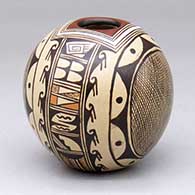 A polychrome seed pot decorated with a four-panel hachure, bird element and geometric design