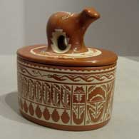 Lidded red jar incised with feather and geometric design