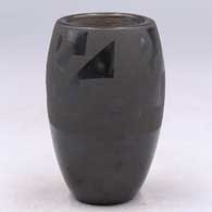 A black-on-black jar with a geometric design