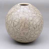 A black-on-tan jar decorated with a fineline and geometric design