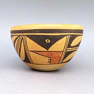 A polychrome bowl decorated with a geometric design and fire clouds
