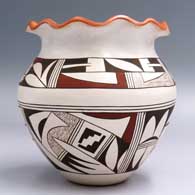 Polychrome jar with a pie crust rim and a geometric design