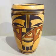 A polychrome cylinder decorated with a two-panel bird element and geometric design
