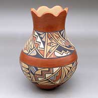 A polychrome vase with a scalloped rim and decorated with a band-of-feathers and geometric design
