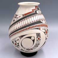 A polychrome jar with a rolled lip and decorated with a 2-panel sickle and geometric design