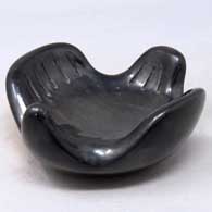 A black stylized bird figure